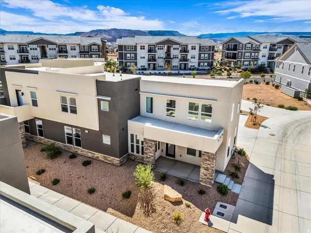 Contemporary architecture featuring a multi-story design, stone accents, and varied exterior finishes