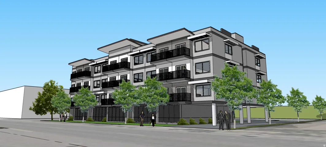 Multi-story building featuring a contemporary facade, multiple balconies with black railings, and varied gray exterior finishes