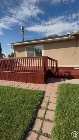 Rear wood deck with red finish, featuring a privacy railing