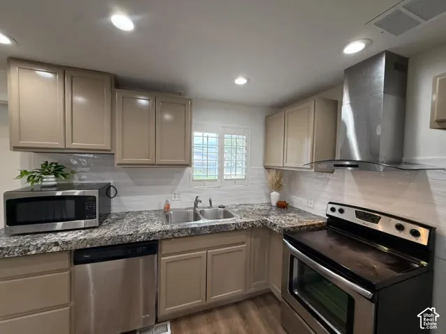 Kitchen featuring stainless steel appliances, recessed lighting, shaker-style cabinetry, a double basin sink, and a tiled backsplash