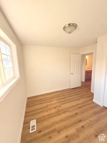 Light wood-finish flooring with crisp white walls
