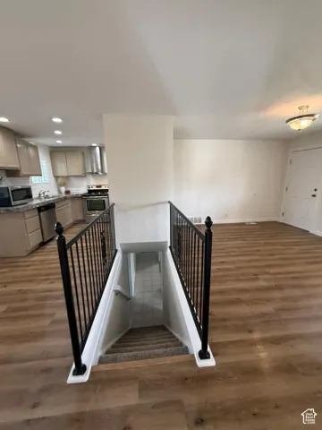 Open-concept living space with wood-finish flooring