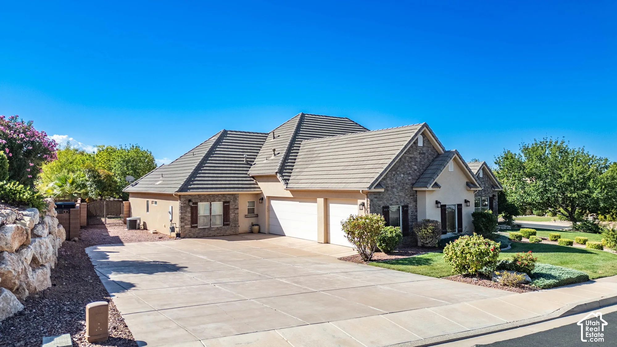 Stone and stucco exterior with a tiled roof