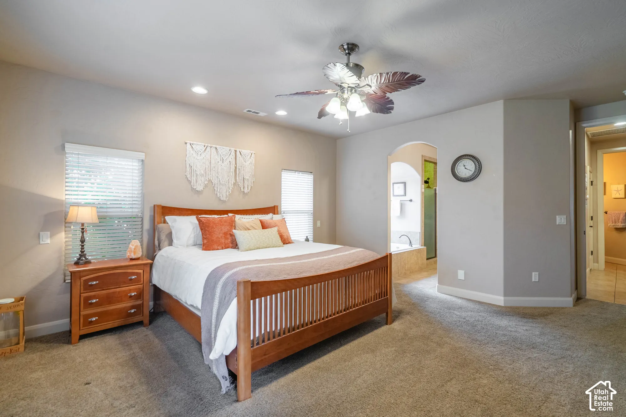 Recessed lighting, ceiling fan with light fixture, arched doorway, and built-in tub with tile surround