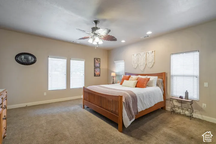 Recessed lighting, ceiling fan with light fixture, multiple windows with blinds, and neutral wall tones