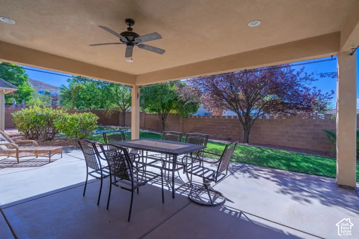 Spacious covered patio featuring a ceiling fan and recessed lighting