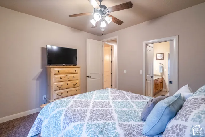 Textured carpeting, neutral wall tones, and a ceiling fan with integrated lighting