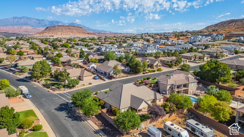 Expansive residential neighborhood with diverse architectural styles, mature landscaping, and an inground swimming pool