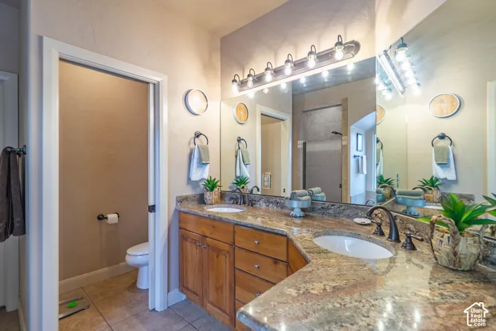 Dual vanity with granite-style countertops, integrated undermount sinks, and oil-rubbed bronze fixtures