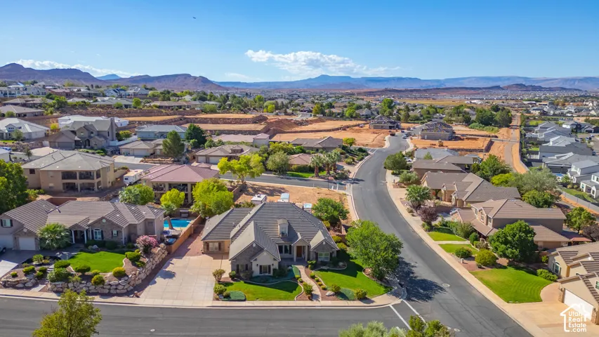 Expansive neighborhood with diverse architectural styles, mature landscaping, and mountain scenery