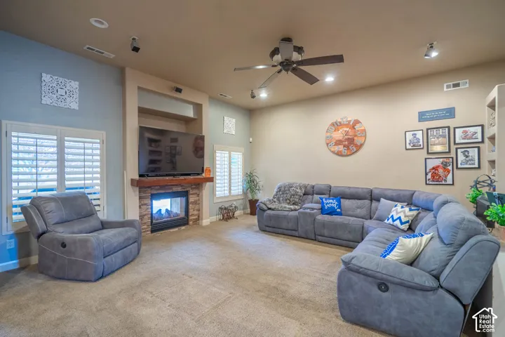 Recessed lighting throughout, accompanied by a ceiling fan