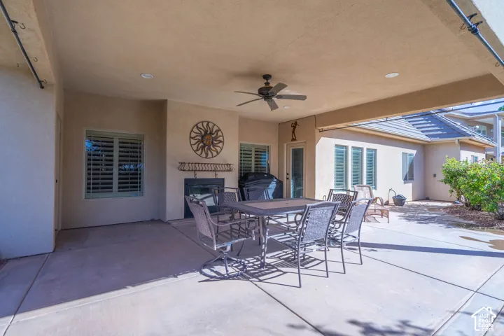 Covered patio featuring an outdoor fireplace, recessed lighting, and a ceiling fan