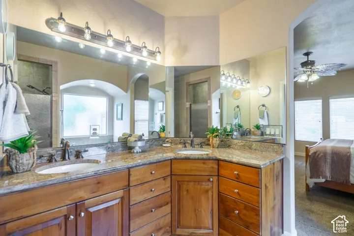 Dual vanity with wood cabinetry and stone countertops