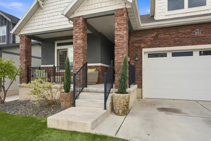Stone veneer columns and facade accent a multi-textured exterior