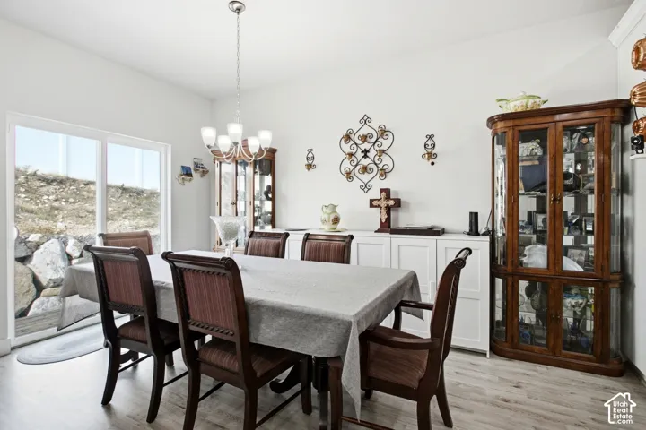 Sliding glass door, wood-finish flooring, recessed lighting, built-in storage cabinetry, multi-light chandelier