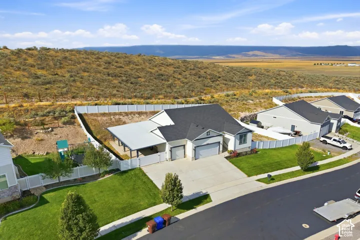Single-story residence featuring a two-car garage, covered patio, and a fenced backyard