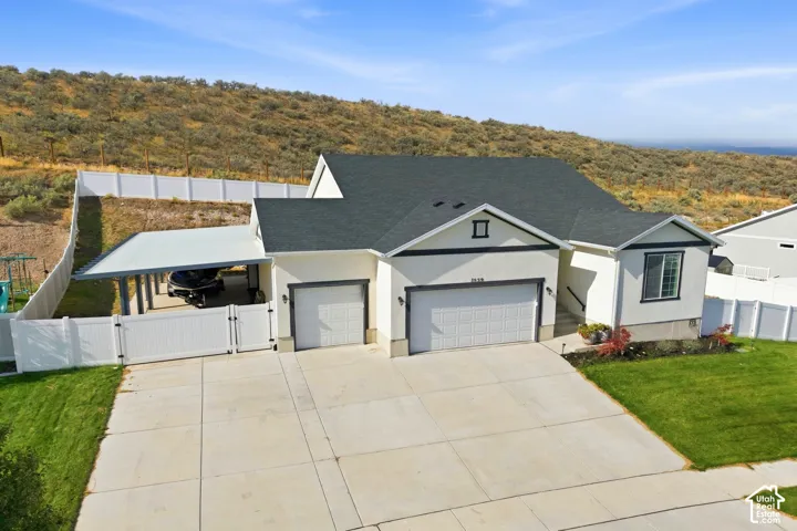 Contemporary exterior with a dark shingle roof and white siding
