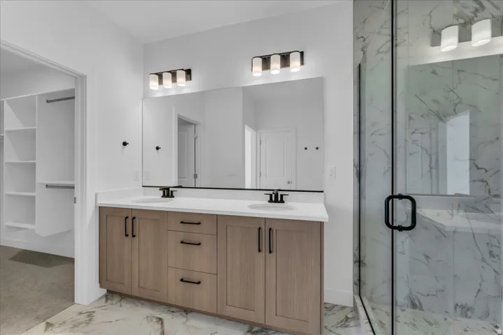 Dual vanity with wood-finish cabinetry and white countertops