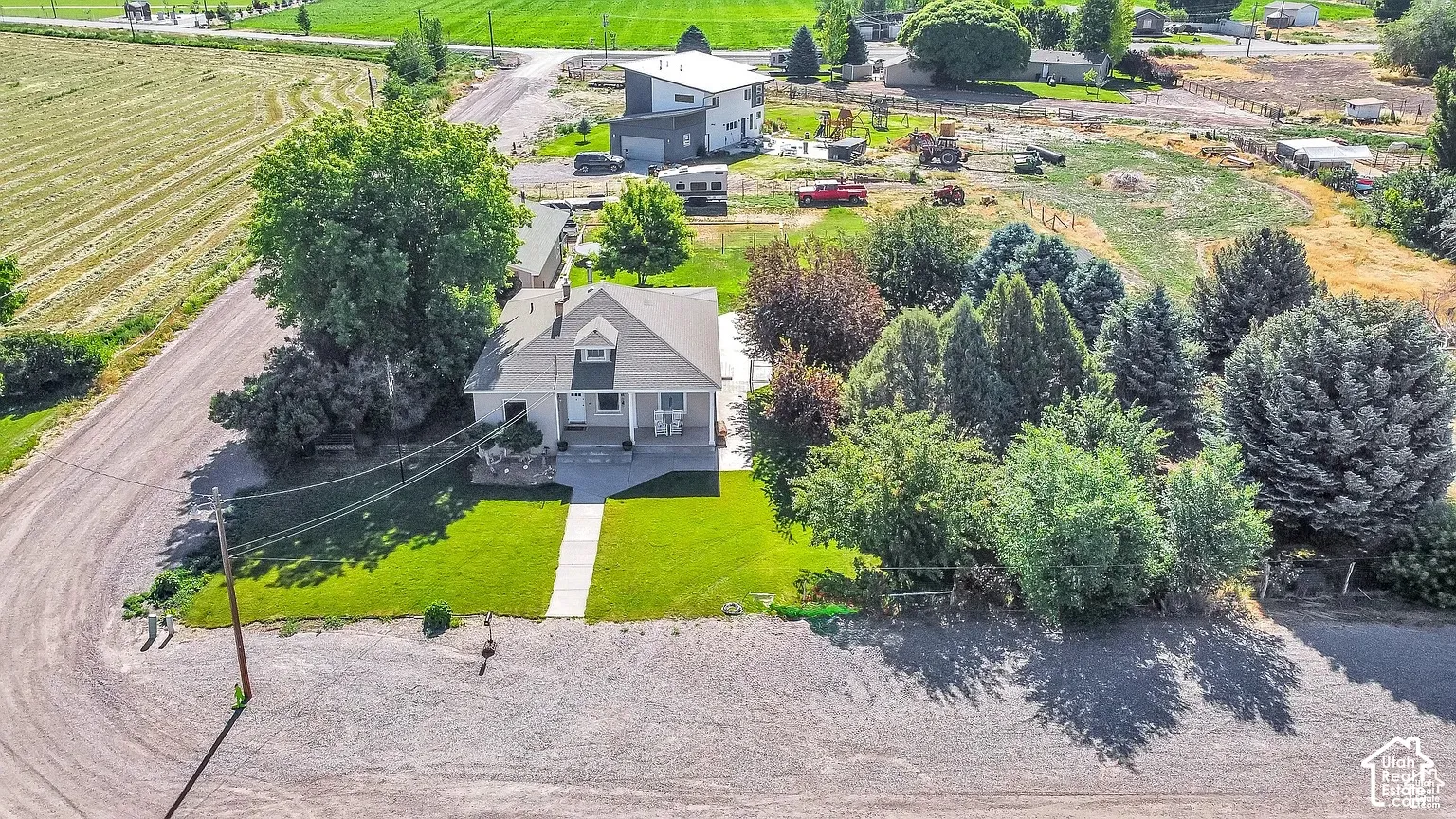 Gabled roofline residence featuring a manicured lawn, established landscaping, and a concrete pathway leading to the entrance