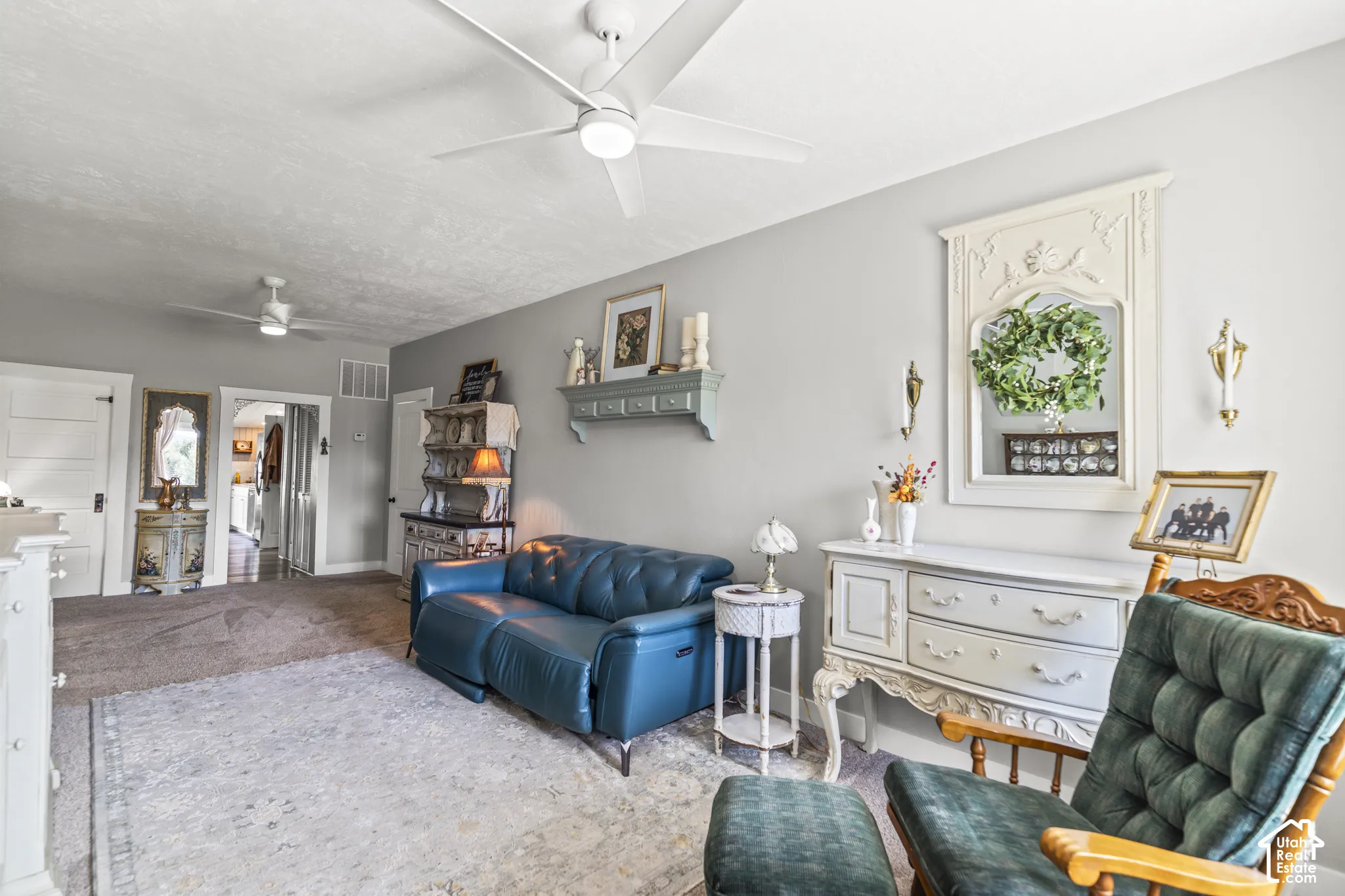 Carpeted flooring, ceiling fans, and neutral wall paint