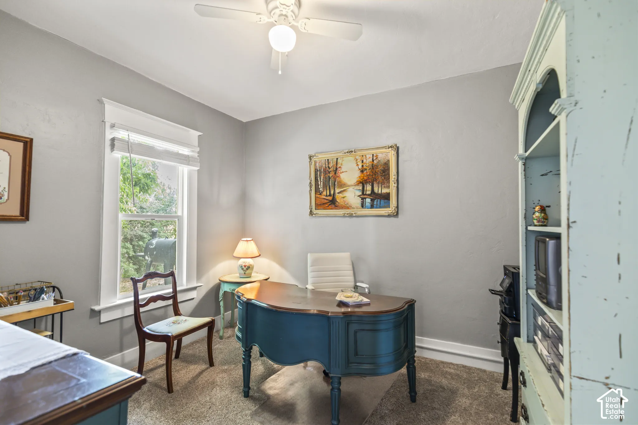 Recessed window with white trim, light gray walls, and ceiling fan