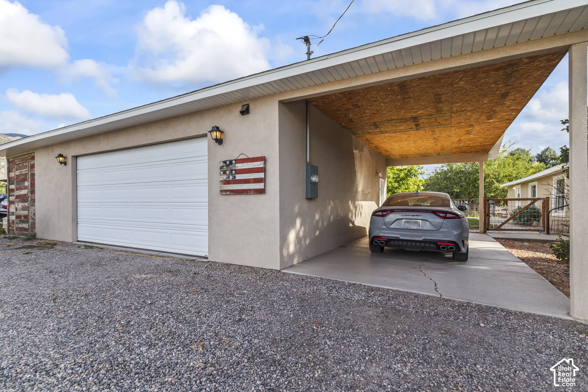 Attached two-car garage and a concrete carport