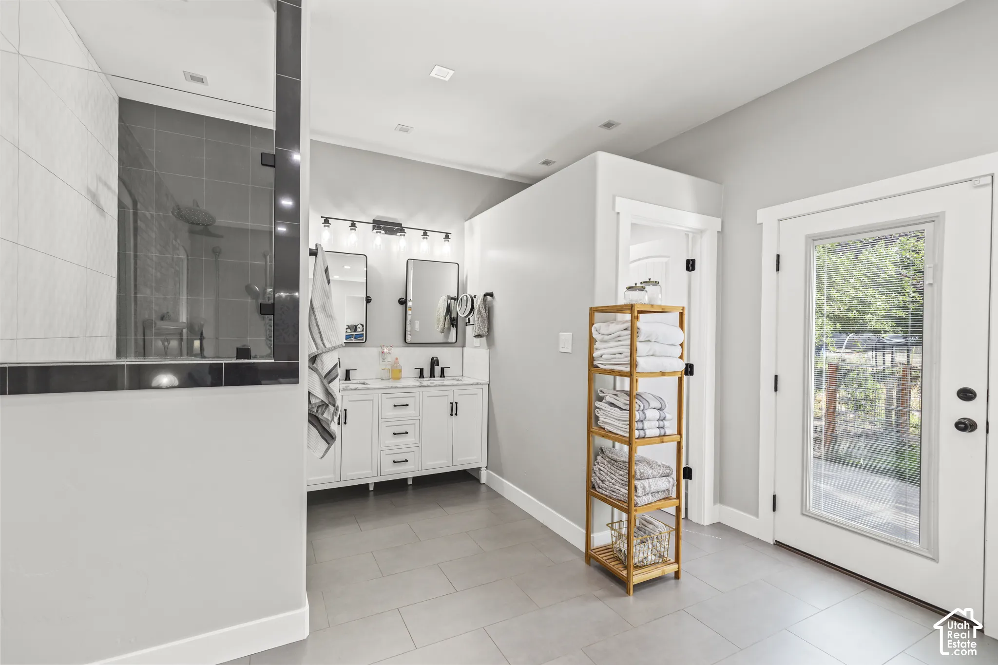 Dual vanity with undermount sinks, frameless mirrors, and black fixtures