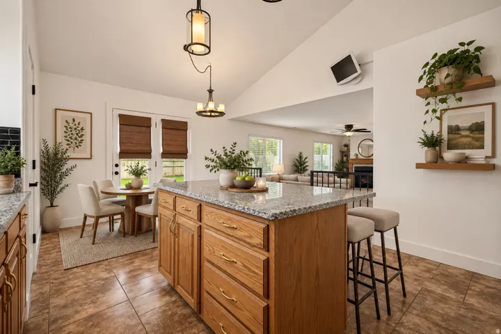 Virtually staged:Kitchen island with granite countertop, wood cabinetry, and integrated breakfast bar
