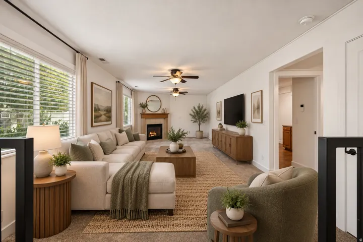 Virtually staged:Carpeted living area featuring a fireplace with a wood mantel, multiple ceiling fans, and large windows with blinds