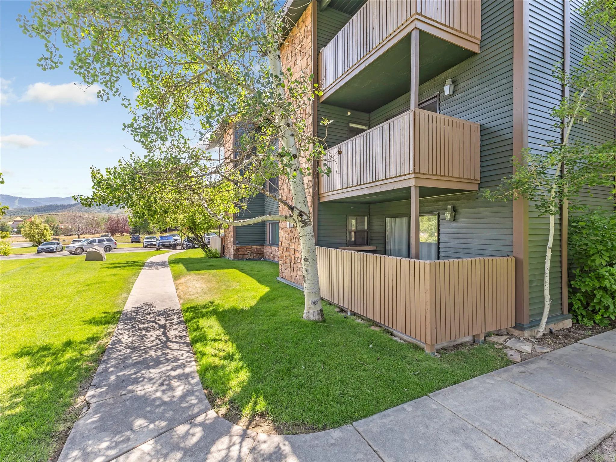 Multi-story building with horizontal siding and stone veneer accents