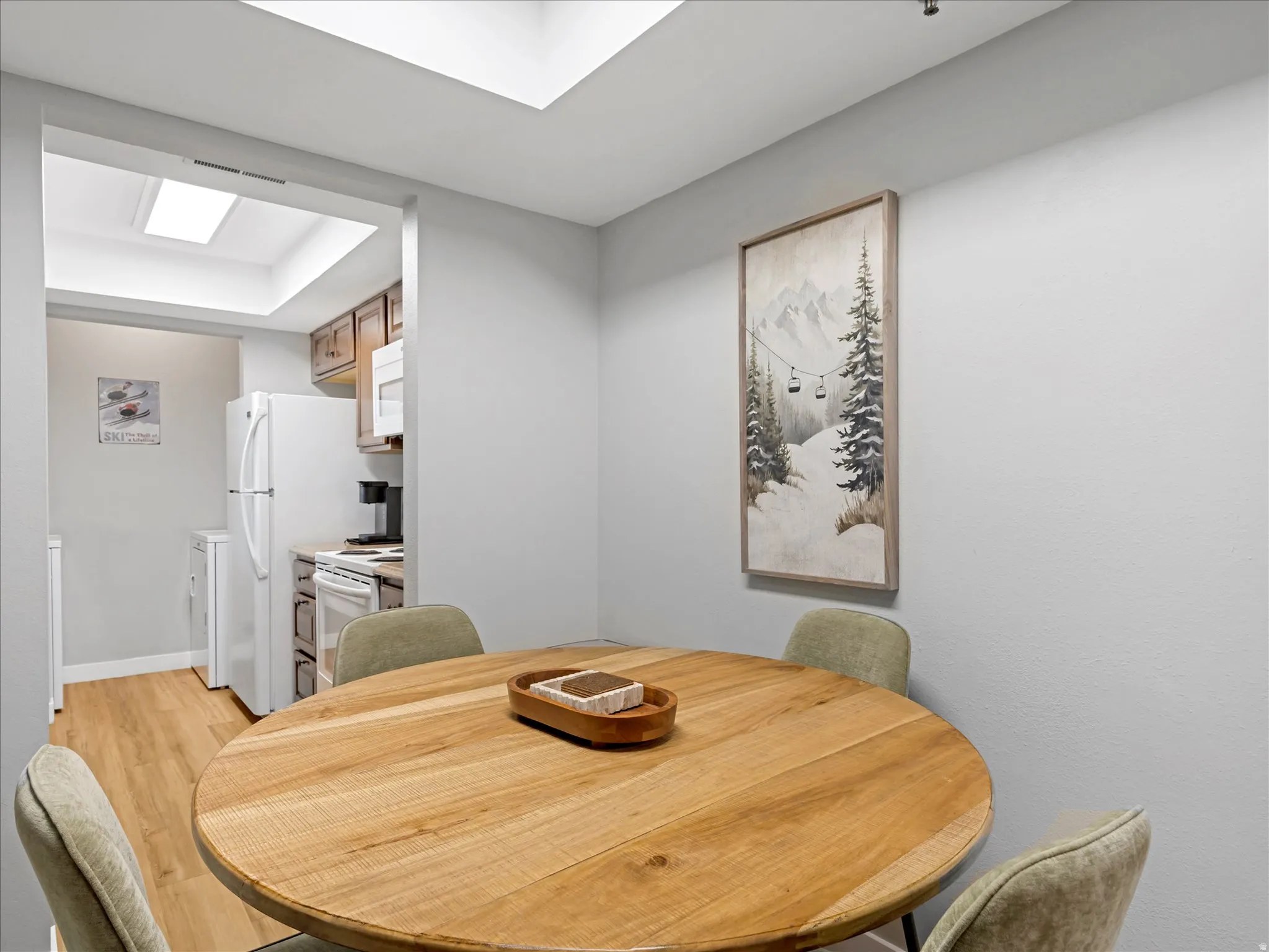 Wood-finish flooring, recessed lighting, and skylights enhance the interior