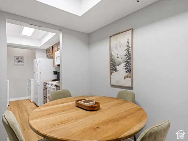 Wood-finish flooring, recessed lighting, and skylights enhance the interior