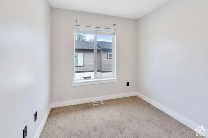 Recessed window with white trim, light-colored walls, and neutral carpeting