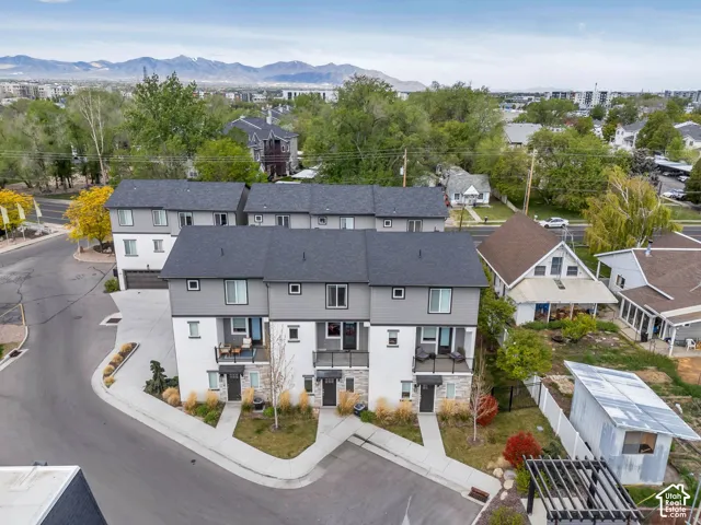 Modern townhome-style residences featuring dark gray siding and white exterior finishes