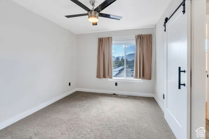 Textured carpeting, white walls, and a window with mountain scenery
