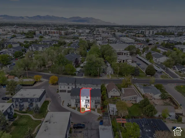 Townhome property with multi-level construction, attached garage, and mountain backdrop