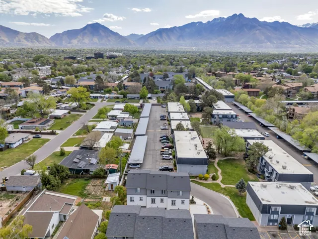 Expansive residential community featuring multiple buildings, covered parking structures, and a paved street network