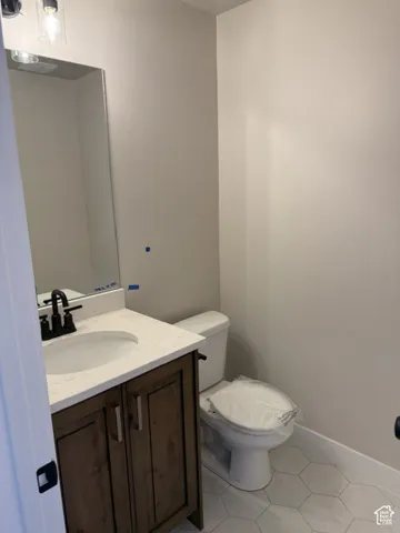 Wood-finish vanity with a light-colored countertop and an undermount sink