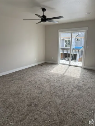 Neutral-toned carpeting throughout, complemented by a modern matte black ceiling fan