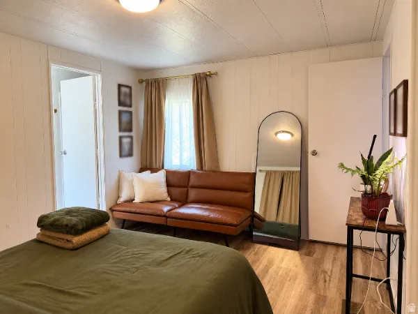 Wood-finish flooring with white vertical paneling