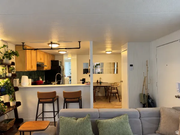 Kitchen featuring wood cabinetry, black appliances, and a breakfast bar
