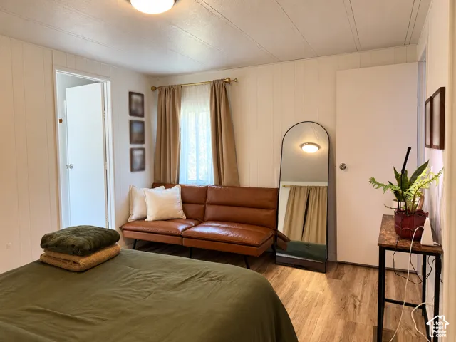Wood-finish flooring with white vertical paneling