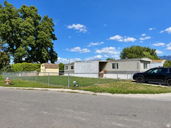 Chain-link fence enclosing a grassy yard