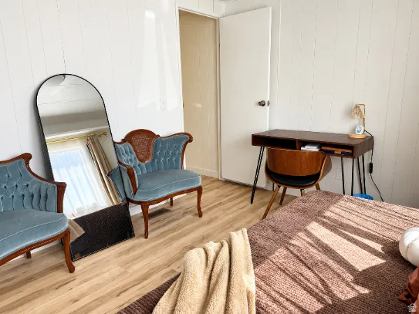 Wood-finish flooring with vertical paneling on walls