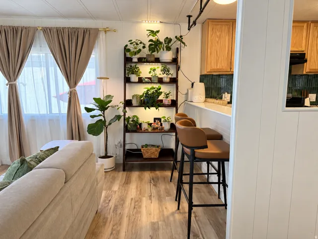 Wood-finish flooring throughout, white paneled walls, and a recessed ceiling