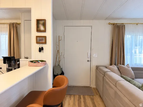 Wood-finish flooring with white paneled walls