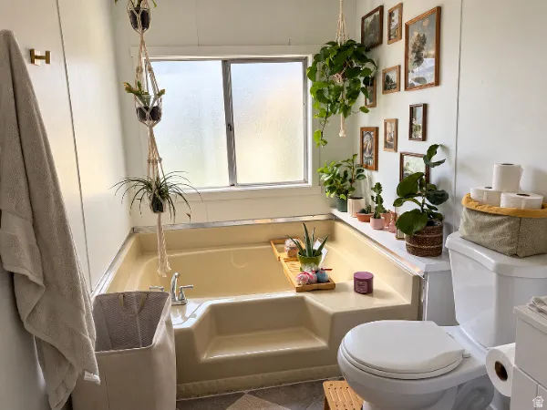 Recessed bathtub with a frosted window and chrome fixtures