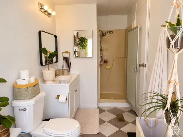 White vanity with integrated sink, rectangular black-framed mirror, and a built-in shower stall
