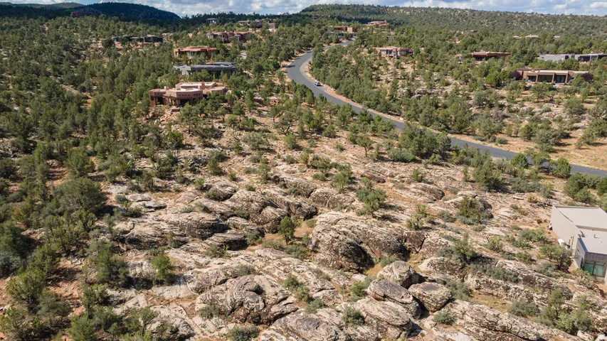 Expansive terrain featuring natural rock formations and abundant natural growth