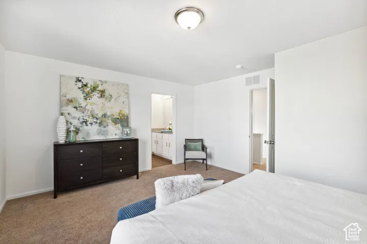Plush carpeting throughout, white painted walls, and a semi-flush ceiling light fixture
